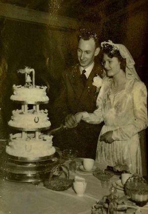 The couple cut the cake on their wedding day in 1950