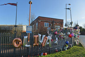 Balloons, flowers and messages left at the scene of the collision