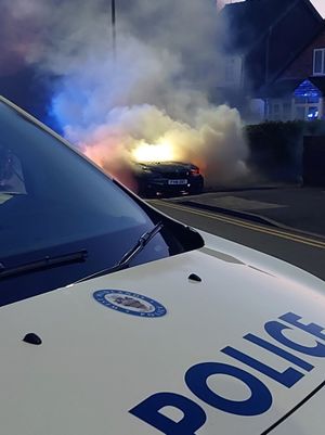 Pictures taken at the scene show the car on fire. Photo: West Midlands Police