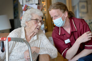 Care home resident Hilda Cross with care assistant Andy Breeze