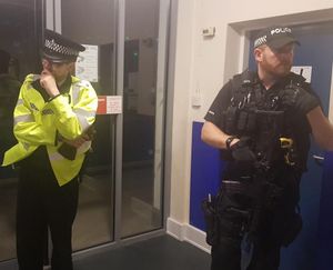 An armed police officer, right, at the South Staffordshire count in Codsall