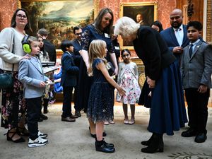 The Queen speaks to one of the finalists of the 500 words competition