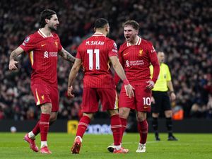 Liverpool’s Alexis Mac Allister celebrates with Mohamed Salah