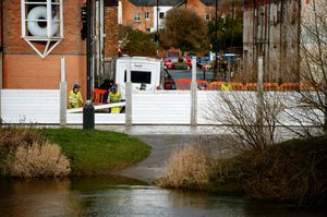 Temporary barriers are used to stop flooding reaching buildings in Frankwell