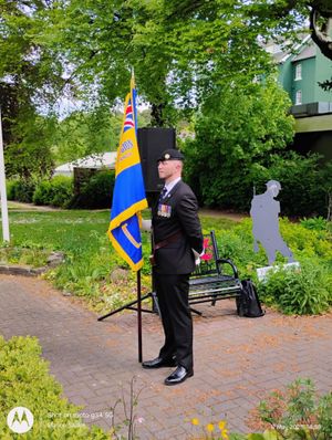 Standard bearer Rhodri Evans in Llandrindod Wells' Memorial Gardens. Image: Marion Sadler