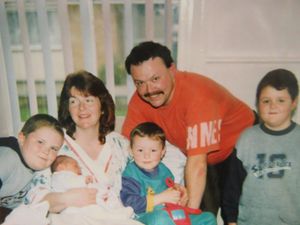 Georgina as a newborn with her family, including her mum Angela