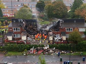 Emergency workers at the smoking ruin of the building