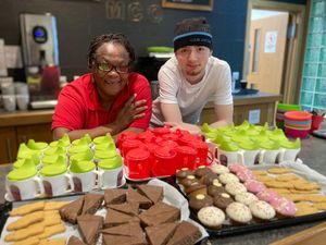 Volunteers Yvonne and Max ready to serve cakes and drinks at the playgroup.