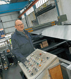 Machine operator Ken Fellows operating a new machine which is more suited to the demands of the firm's latest venture