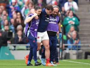 Antoine Dupont limping off the pitch