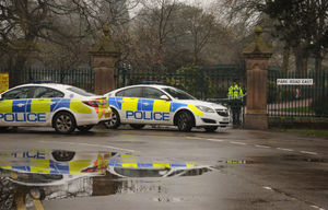 Patrol cars outside a park entrance on Park Road East