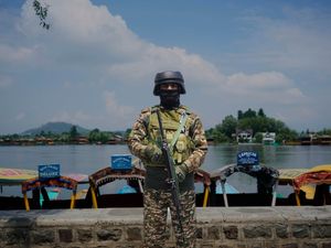 An Indian paramilitary soldier stands guard on the banks of Dal Lake