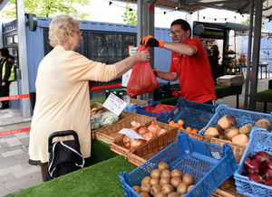 Paul Peacock serves customer Margaret Johnson