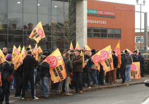 Firefighters demonstrate outside West Midlands Fire Service headquarters in Birmingham