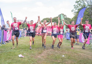 Leanne Quigley crosses the finish line with partner Sophie Jones and friends. Photo: Richard Walker