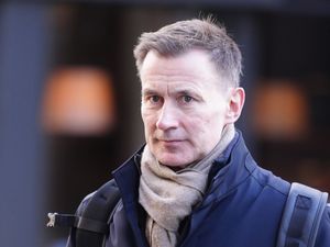 Jeremy Hunt wearing a coat and scarf