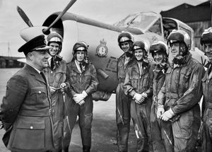 May 19, 1958, the caption reads: 'Group Captain B.R. Beare has recently become station commander at RAF Tern Hill, which has been training pilots since 1916. Altogether, 3,200 pilots have passed through the gates. Group Captain Beare was the first pupil pilot to be trained in January 1936, when the station was reopened. He is pictured here with trainee pilots.'