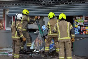 Firefighters from West Midlands Fire Service worked to remove damaged parts of the frontage of the post office