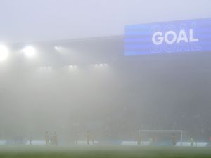 Leicester celebrate as the scoreboard says 'goal' in the fog at the King Power Stadium