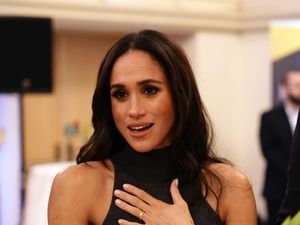 Meghan places her hand on her chest as she chat to people at the Invictus Games in Dusseldorf