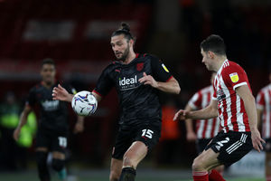 Andy Carroll of West Bromwich Albion and John Egan of Sheffield United  during the Sky Bet Championship match between Sheffield United and West Bromwich Albion at Bramall Lane on February 9, 2022 in Sheffield, England. (Photo by Adam Fradgley/West Bromwich Albion FC via Getty Images).