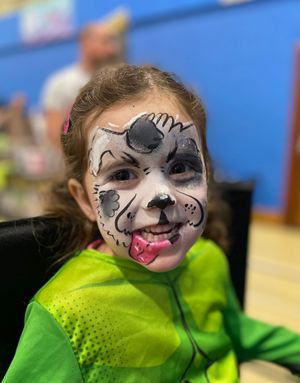Paws-itively adorable! Face painting fun was a hit with the kids at Comic Con—just look at that tail-wagging smile!