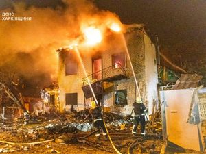 Emergency services personnel work to extinguish a fire following a Russian attack in Kharkiv, Ukraine