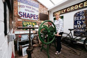 Volunteer Carole Higgins with a Corn Cutter which was made by John Rodenhurst of Cheshire Street in Market Drayton