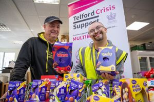 Simon Lellow and Dale Tyler receiving the donation of Easter eggs at Telford Crisis Support