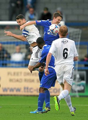Simon Grand of AFC Telford United is caught in the face by Sean McConville of Stalybridge Celtic who was booked and then sent off for a second yellow card for protesting to the referee