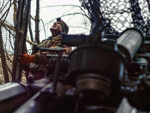 A Ukrainian soldier looks at the sky searching for Russian FPV drones