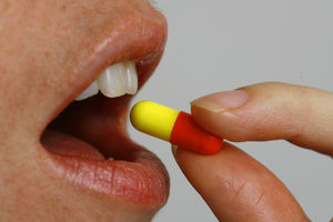 File photo dated 08/11/06 of a woman taking a tablet. Academics called on GPs to "better target" antibiotics for those at highest need after analysing data on millions of prescriptions over a number of years. There have been a number of measures in