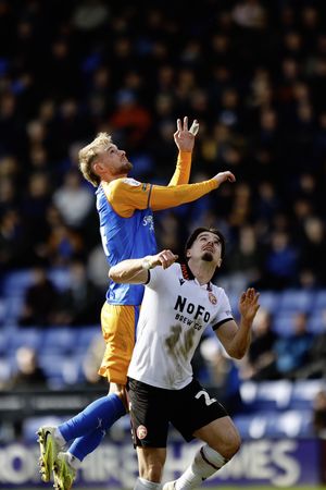 Taylor Perry (left) challenges Jamie Jellis for a header