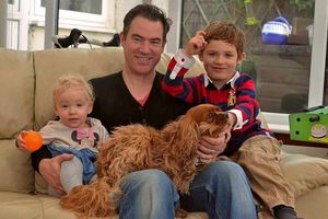 Harrison with sister Sienna, one, father Mark and Tia Maria the dog