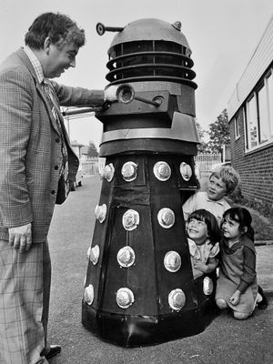 May 22, 1978, the original caption reads: 'Pre-fete fun at St Patrick's Primary School, Wellington, yesterday. A working Dalek, made by people of the parish, had its first airing at the school in preparation for its official appearance at St Patrick's parish fete. Headmaster Mr John Carr is with (from left) five-year-olds Caroline Thomas, Christopher Reynold, and Jenny Lewis.'