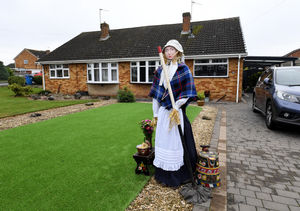 A boat lady made out of straw