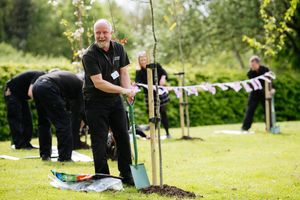 Maintenance Engineer at Ricoh in Telford, Graham Smith, planting a tree as part of the Queen's Green Canopy scheme.