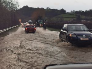 Traffic pushing through standing water on the Welshpool-Shrewsbury road on Tuesday afternoon. Photo: Barry Evans