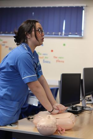 NHS Nurse Ellie Mcintosh teaches students how to perform CPR