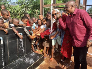 Councillor Hibbert at the commissioning of a water project for a rural community, donated by Imo diasporan Festus Mbisiogu (right)