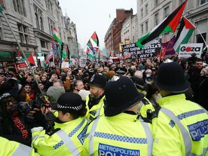 People breach a police line