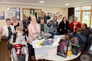 Colleagues and customers at Showell Court handover the latest batch of donations to the Hope Community Project 