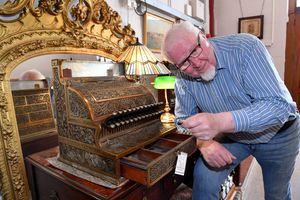 A near 100-year-old cash register has gone up for sale at a Shropshire antiques centre after spending decades in a Midlands pub. Pictured with John Ridgway.