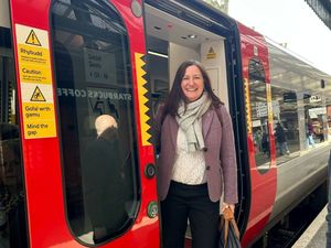 Julia Buckley MP boarding a Transport for Wales train. 