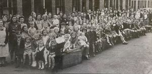 Residents of Bright Street, Whitmore Reans, Wolverhampton, held a massive party to celebrate the end of hostilities. It was supplied by reader Jean Sanders, the three-year-old sitting on the lap of cousin Joan Corfield, immediately right of the flower tub. Also, wearing a turban by the window was Mrs Sanders' mother Gwen Smith.