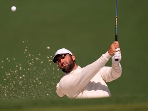 Scottie Scheffler hits from a bunker