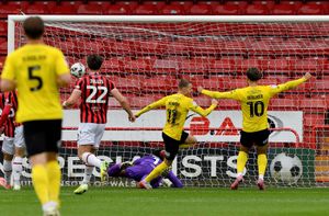 Elliot Newby turns to celebrate after opening the scoring for Barrow.