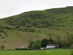 The cottage and log cabins sit on the slopes of Caer Caradoc. Photo: Google Maps