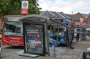 The collision between the two buses left a woman with serious injuries and the bus shelter destroyed