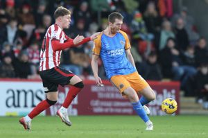 Tom Anderson of Shrewsbury Town and Jake Bickerstaff of Cheltenham Town